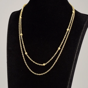 Double-layered gold titanium steel necklace featuring polished bead accents on thin chains