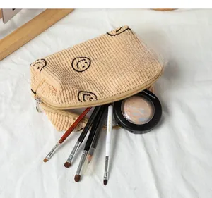 Macro shot of beige corduroy pouch showing capacity for brushes and cosmetics