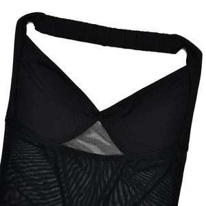 Detail of elegant black tube dress featuring mesh patchwork and a deep V-neckline cut
