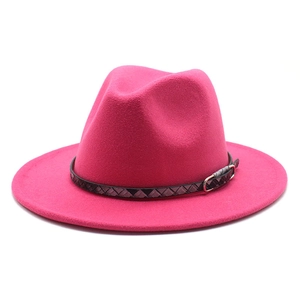 Detail of rose red wool fedora hat featuring a stylish textured band and silver buckle