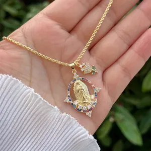 Close-up of 18K gold-plated Virgin Mary and floral pendants with multicolored zircons