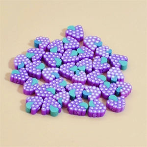 Detailed pile of 10mm heart-shaped purple grape polymer clay beads for DIY jewelry