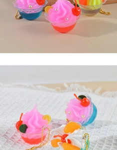 Detailed view of mini ice cream parfait keychains with cream, cherry, and gold chain