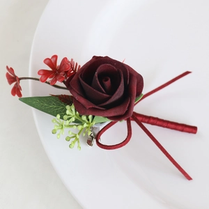 Handmade burgundy PE rose boutonniere with green leaves and ribbon for wedding suits