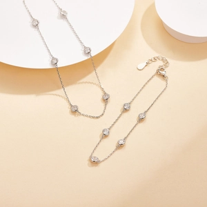 Detail of silver S925 necklace with bezel-set round cubic zirconia and lobster clasp closure