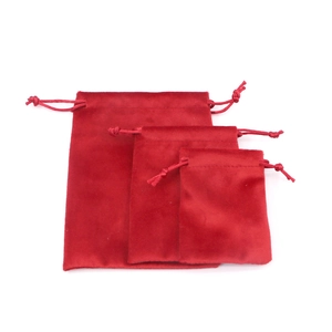 Three sizes of red velvet drawstring pouches stacked on a clean white background