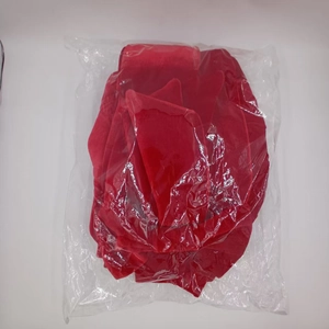 Macro detail of red velvet butterfly wedding decoration folded in clear packaging