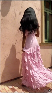 Détail du dos d'une robe rose à volants superposés avec de fines bretelles