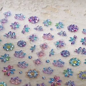 Holographic gold butterfly nail stickers with 3D floral and star metallic designs