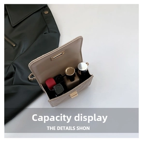Capacity display of a beige quilted mini bag with gold chain strap and metal lock