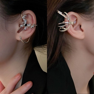 Silver spider earring with black stone and layered streamline ear cuff on model