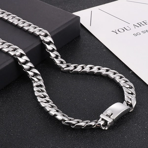 Detailed macro shot of 12mm silver stainless steel Cuban link chain with secure clasp