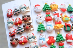 Macro shot of assorted Christmas hair clips with Santa, reindeer, and snowman designs