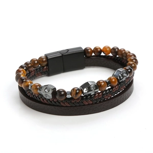 Detailed view of multilayer leather bracelet with tiger eye beads and metal skulls