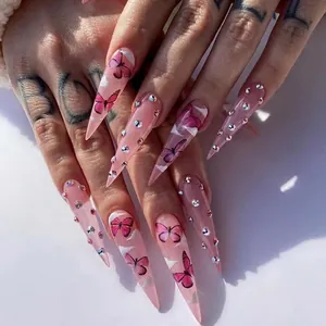 Long stiletto press-on nails featuring pink butterflies, white clouds and rhinestones