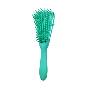 Detail view of the flexible bristles and curved green head of the detangling hair brush