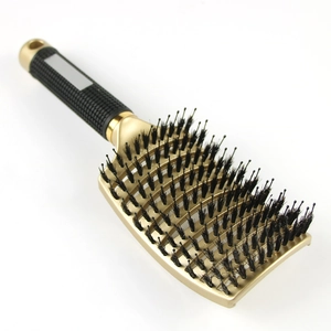 Curved boar bristle hair brush in gold with ergonomic black handle for styling