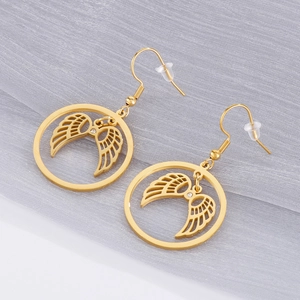 Golden round hollow angel wing earrings with white crystals on a grey soft tulle background