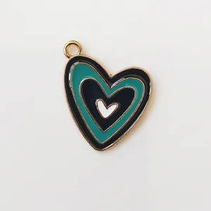 Detailed view of multilayer colorful enamel heart pendant with golden metal edges for DIY jewelry