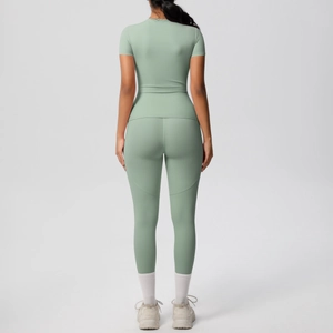 Back view of yoga set featuring slim-fit short sleeve top and high-waist leggings in sage green