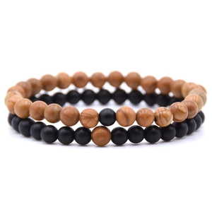 Close-up of distance bracelets with 8mm brown wood and matte black stone beads