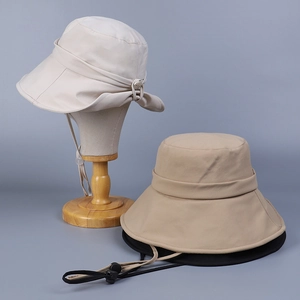 Detail of wide brim sun hats in cream and khaki with adjustable windproof chin straps