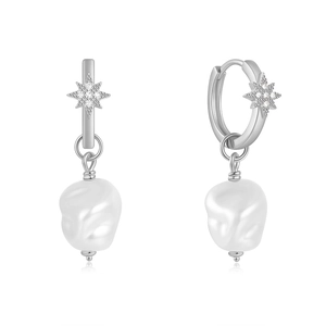 Close-up of silver star earrings with pavé zircons and baroque pearl drops on white background
