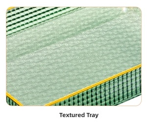Close-up of green candy tray featuring floral wave texture and yellow contrast edges