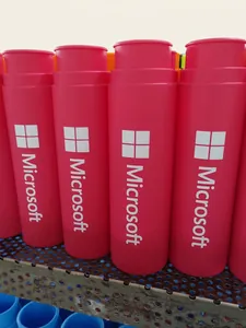 Macro shot of rose red foldable silicone bottle with white logo on blue rack