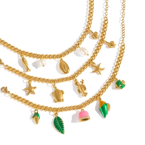 18K gold plated multi-layer necklace with sea life charms and natural pearls on white backdrop