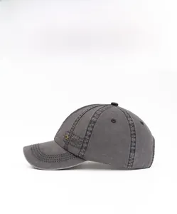 Detail shot of vintage washed cotton baseball cap with side metal eyelets and stitching