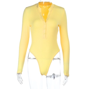 Close-up of yellow ribbed knit bodysuit featuring long sleeves and button-up V-neckline