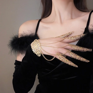 Detailed view of golden hollow flower armor rings connected to a vintage gothic hand chain