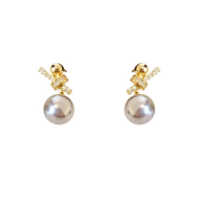 18k gold plated pearl earrings with cross knot zircon design on a white background