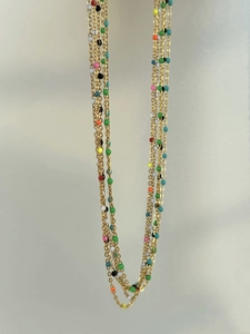 Detail of multi-layered 18k gold plated necklace with colorful enamel bead accents