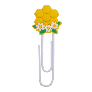 Close-up of white metal paperclip with a cute yellow honeycomb daisy PVC charm decor