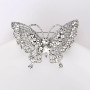 Detailed macro view of the silver butterfly brooch featuring intricate rhinestone inlay
