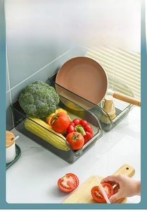 Macro detail of grey plastic kitchen storage bins with U-shaped open front design