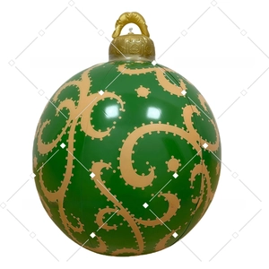 Detailed view of an inflatable green Christmas ball with gold patterns and top handle
