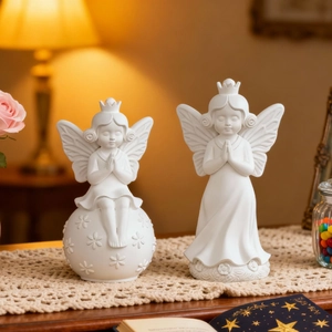 Detailed view of two praying angel figurines made of white matte silicone resin mold design