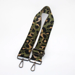Macro view of leopard print wide strap with gun-black metal lobster clasps and buckles
