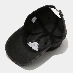 Detail view of cotton baseball cap interior showing 100% cotton tag and embroidery