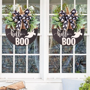 Halloween wooden door sign featuring white ghosts, green plants, and hello BOO text on white doors