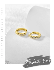 Macro detail of gold-plated hoop earrings with micro-pave white cubic zirconia row