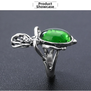 Macro shot of punk spider ring featuring a large green crystal and vintage silver finish