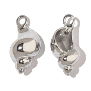 Macro view of shell-shaped stainless steel pendant showing front and internal structure