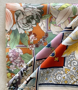 Macro shot of vibrant floral patterns and textures on luxury mulberry silk neck scarf
