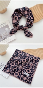 Close-up of navy blue floral scarf with pink lace edges and elegant flower print details