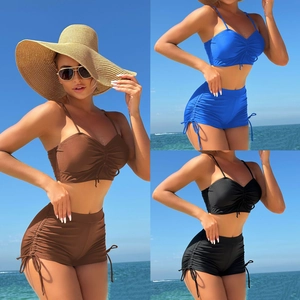 Detail of two-piece swimwear set showing side drawstring ruching and solid colors