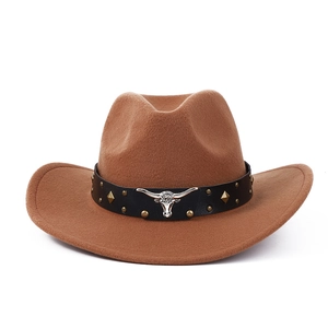 Close-up of brown wool cowboy hat featuring a leather band and silver bull head emblem